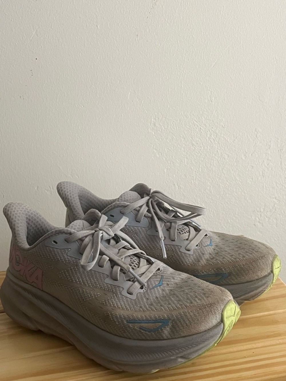 Hoka Light Gray Athletic Shoes with Blue Accents and Neon Yellow Toe